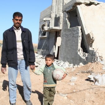 man with child in Gaza